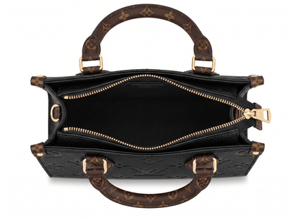 Black embossed monogram tote bag interior view showing zip closure and lining