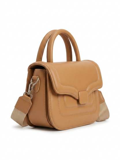 Camel leather flap bag side angle view with top handle and crossbody strap
