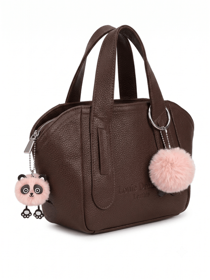 Brown pebbled leather mini satchel angle view with panda and pom-pom charms