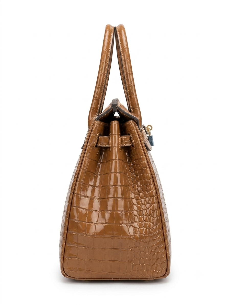 Tan crocodile-embossed leather tote bag side view showing structured silhouette