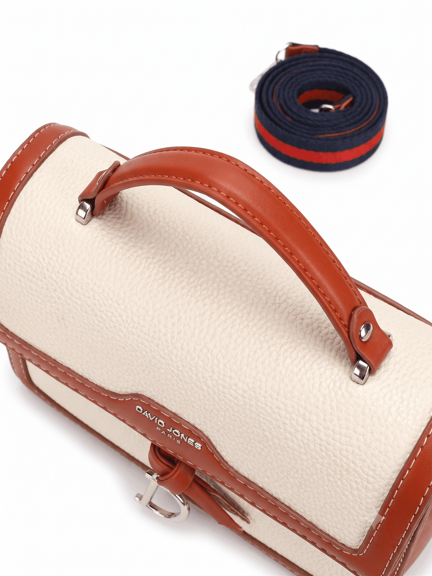 Cream canvas satchel bag angle view with striped crossbody strap