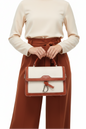 Cream canvas satchel bag top-down view showing structured handle and canvas texture